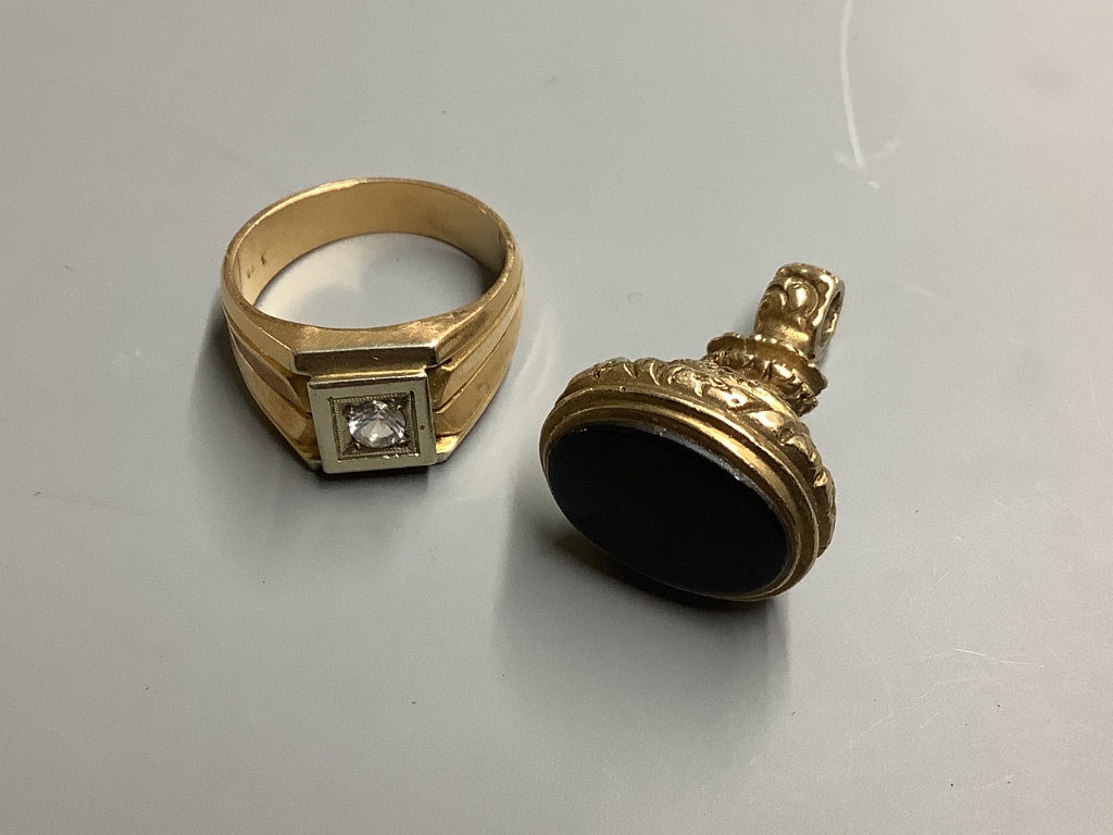 A yellow metal and paste? set signet ring, size U/V, gross weight 14 .1 g, together with a yellow metal overlaid and black onyx fob seal.